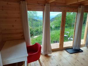 a room with a red chair and a large window at Grand Chêne in Saint-Racho +16 photos