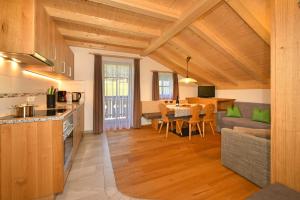 a kitchen and a living room with a table at Feldererhof Gsies Apt Almenblick in Valle Di Casies