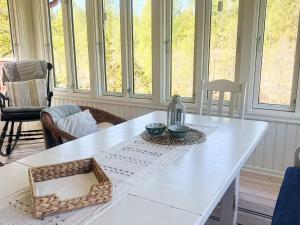 a white table in a room with windows at 5 person holiday home in Häradsbäck in Ryd
