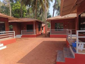 a couple of buildings with palm trees in the background at Silver Shark Boutique Villas in Ajgaon +9 photos