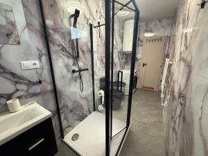 a bathroom with a shower and a sink at Self-Check- New Home in Levice +30 photos