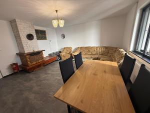 a living room with a wooden table and a couch at Self-Check- New Home in Levice