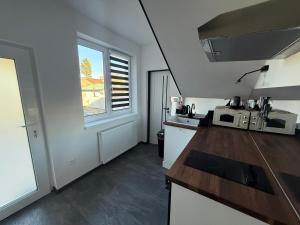 a kitchen with a counter top and a window at Self-Check- New Home in Levice