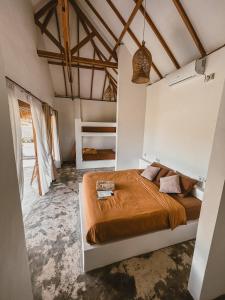 a bedroom with a bed in a room at Muara Surf House - Yoyos beachfront in Sekongkang