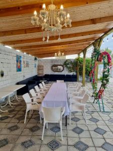 a dining room with a table and chairs and a ceiling at Laguna House next to Pool at Bazaleti Lake in Bazalet'i