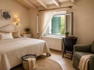 a bedroom with a bed and a window and a chair at Kaloudis Studios & Apartments in Dassia