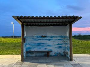a blue shed with a bench in a field at Pousada Açaí in Ilha Comprida +7 photos
