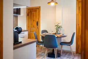 a small kitchen with a table and chairs in a room at Zviedru Nams in Liepāja