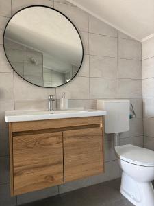 a bathroom with a white toilet and a mirror at Ivano & Franko apartments in Kruševo +31 photos