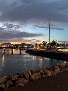 a body of water with a sail boat in the distance at Ulia in Arrecife