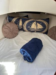 a blue towel sitting on a bed with pillows at Ulia in Arrecife +7 photos
