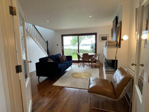 a living room with a couch and a table at 4 Harbour Town House in Westport