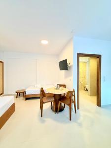 a room with a bed and a table and chairs at Kapetánissa Concept Studios in Stalís