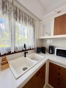 a kitchen with a sink and a window at Kapetánissa Concept Studios in Stalís +37 photos