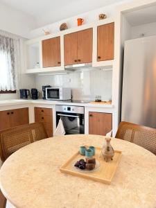 a kitchen with a table with a tray of food on it at Kapetánissa Concept Studios in Stalís