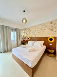 a bedroom with a large bed in a room at Kapetánissa Concept Studios in Stalís