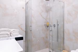 a shower with a glass door in a bathroom at Hotel Kamomil in Durrës +50 photos