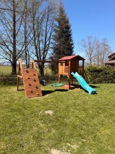a playground with a slide and a play structure at Chata Šuhaj in Liptovský Mikuláš