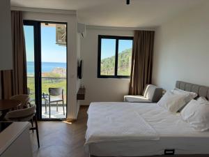 a bedroom with a bed and a view of the ocean at Maresa 4 in Čanj