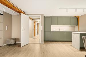 an open kitchen with green cabinets and a table at 2026 New built Aparthotel - 5 units - 4BR - 2BR - SKB17 in Bergen +67 photos