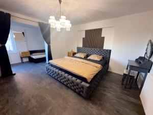 a bedroom with a bed in a room with a piano at Self-Check- New Home in Levice
