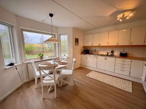 a kitchen and dining room with a table and chairs at Falkenbergsvägen 1C, Ullared in Ullared