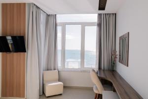 a living room with a large window with the ocean at Hotel Kamomil in Durrës