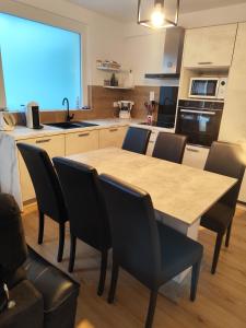 a kitchen with a table and chairs in a kitchen at Appartement Centre Ville in Questembert