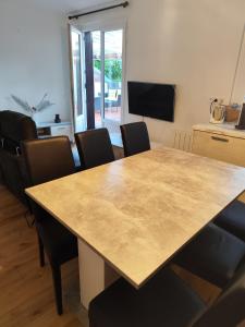 a dining room with a large wooden table and chairs at Appartement Centre Ville in Questembert