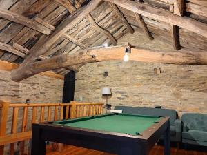a room with a pool table in a building at Casas do Campo in Monfero