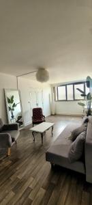 a living room with a couch and a coffee table at Paris Appartement 2-pièce Master Bedroom Romantique in Alfortville +2 photos