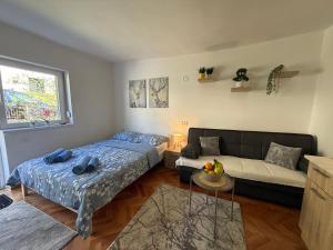 a living room with two beds and a couch at Mont in Rudnik