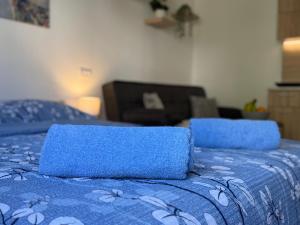 a blue bed with a blue blanket with flowers on it at Mont in Rudnik