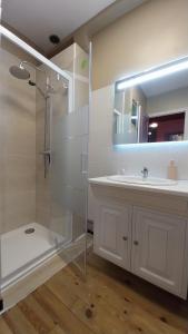 a white bathroom with a shower and a sink at 50 nuances de couleurs in Arinthod