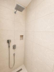 a shower with a shower head in a bathroom at Little Vine House in Mostar +17 photos