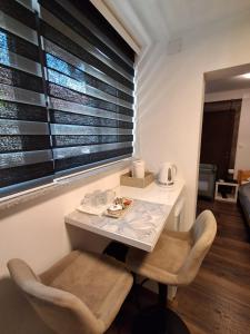 a table and chairs in a room with a window at Apartment Allapera in Svibovec Podravski