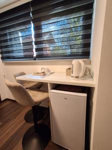 a desk in a room with a window with blinds at Apartment Allapera in Svibovec Podravski +12 photos