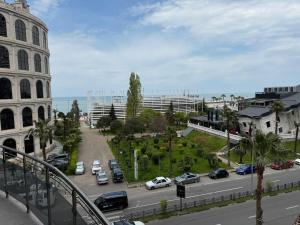a view of a street with cars parked on the road at ORBI 4 Seasons ApartHotel in Batumi