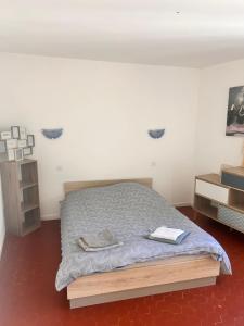 a bedroom with a bed and a dresser in it at Charmant T3 au centre de gréoux les bains in Gréoux-les-Bains