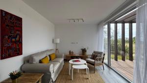 a living room with a couch and a table at LAZY HIKERS by Nature Bliss in São Luis