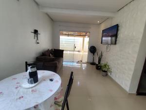 a living room with a table and a couch at Aluguel por Temporada Marabá - São Félix in Marabá +4 photos