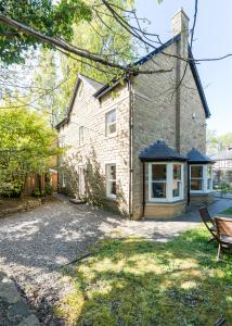 a brick house with a driveway in front of it at The Clubhouse in Sheffield