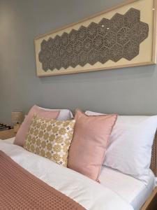 a white couch with pillows on top of it at Rroji Urban Heritage - Boutique Rooms & Serviced Apartments in City Center in Shkodër