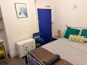 a bedroom with a bed and a blue door at Smart Double Room in Reading