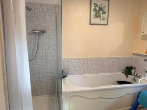 a bathroom with a bath tub and a sink at Smart Double Room in Reading