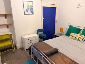 a bedroom with a bed and a blue door at Smart Double Room in Reading