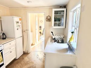 a kitchen with a white refrigerator and a table at Smart Double Room in Reading
