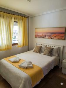 a bedroom with a large bed with two towels on it at Navarubia in Navacerrada