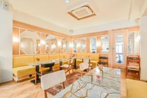 a restaurant with tables and chairs in a room at Hotel Habituel in Paris