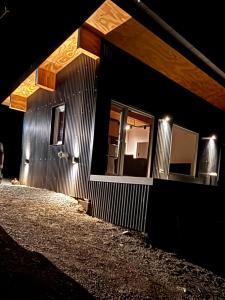a building with lights on the side of it at night at Kattyjaus in San Carlos de Bariloche